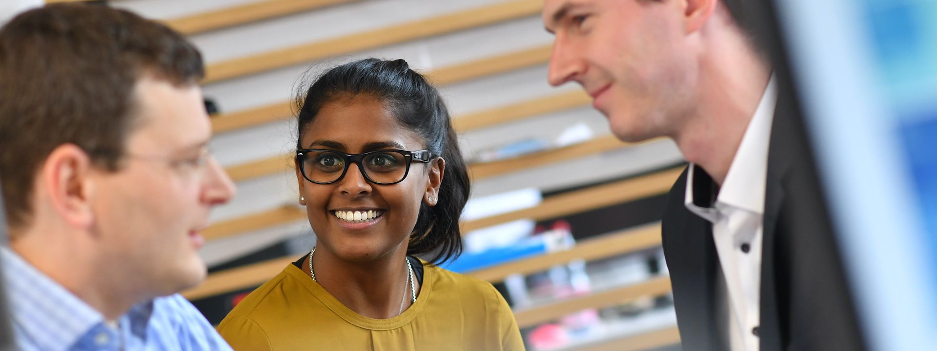 Three employees in conversation